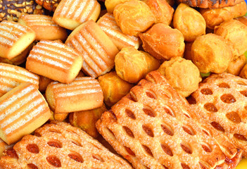Shortbread, puffs and cookies covered with chocolate and grind n