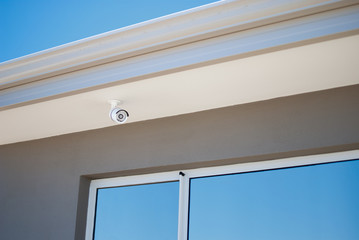 Security camera surveiling the outside of a house