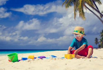 Fototapeta na wymiar little boy playing on sand beach