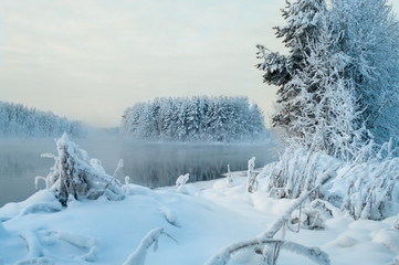 Winter landscape, islands and shore unfrozen lake