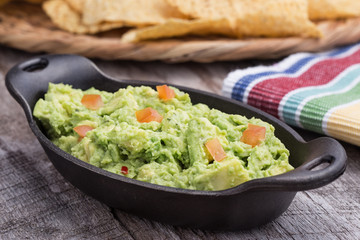 Chunky homemade guacamole in cast iron dish