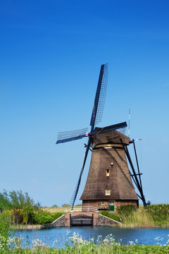 View of windmill on arrogation channel in Holland