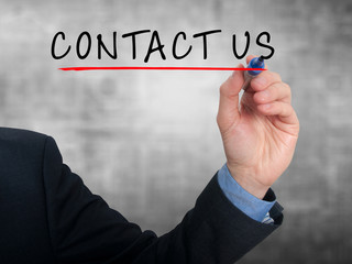 Businessman hand writing contact us. Grey background