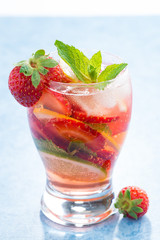 cocktail with fresh strawberries and citrus in glasses, vertical