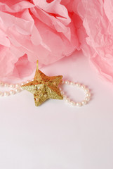 Decorative star, pearl beads and pink pom pom.