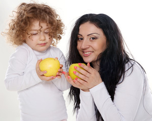 The child with mother holding apple isolated