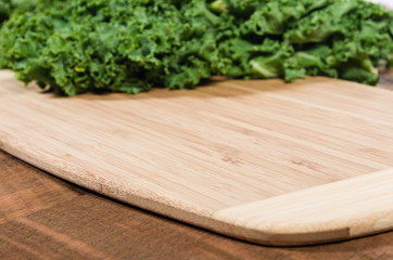 Curly kale leaves on cutting board