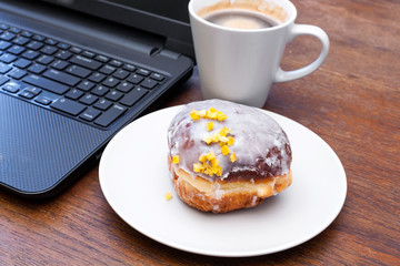 Fat Thursday - donut, coffee and a laptop.