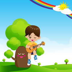 Cute Little boy child playing a music guitar on tree