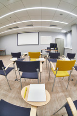 Empty classroom with сhairs and notepads