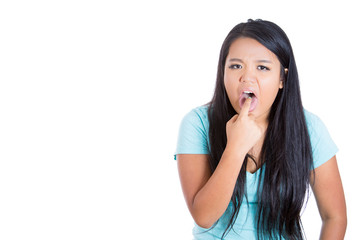 Woman disgusted finger in mouth gesture on white background 