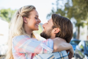Fototapeta premium Attractive couple standing and hugging
