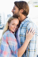 Fototapeta premium Attractive couple standing and hugging