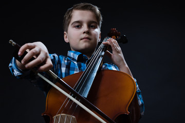 young Cellist playing classical music on cello