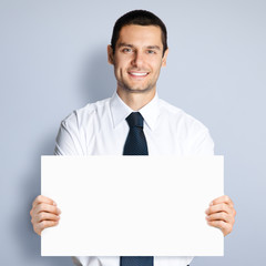 Businessman showing blank signboard