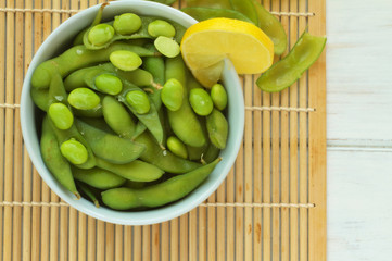 Edamame, soy beans on a wooden background