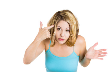Fototapeta premium Woman gesturing with finger against temple asking are you crazy 