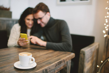 Young couple in cafe sitting with smartphone and Young couple in