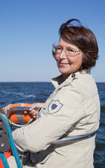 Elderly woman yachtsman on a sailing yacht