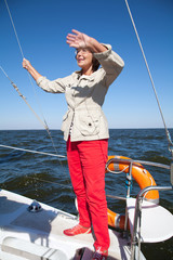 Elderly woman yachtsman on a sailing yacht