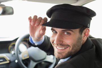 Handsome chauffeur smiling at camera