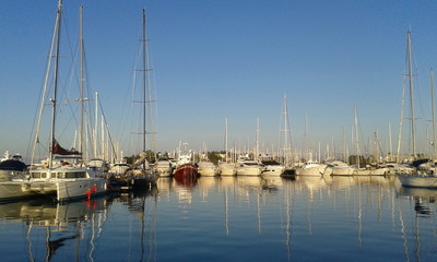 Fototapeta na wymiar Yachts and sail boats reflected in a Marina