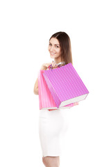 Beautiful smiling girl carrying colorful shopping bags