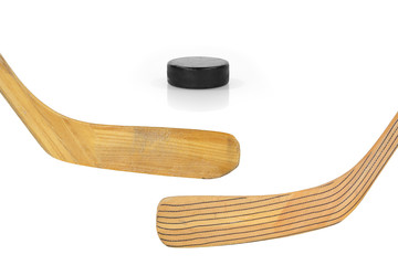 Two hockey sticks and puck