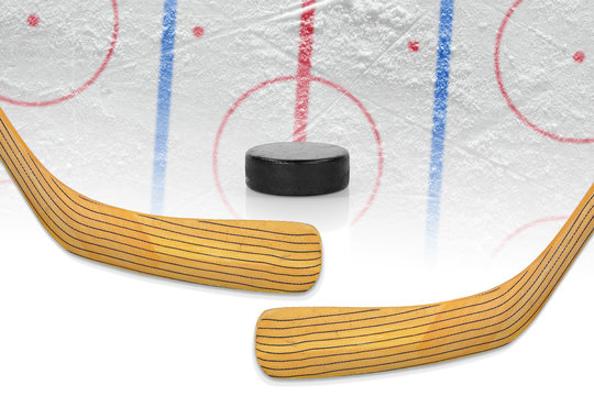 Two hockey sticks, puck and hockey field