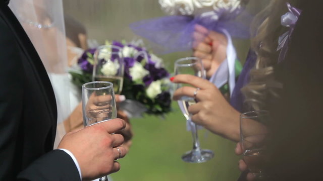 People communicate on a banquet with glasses in hands.