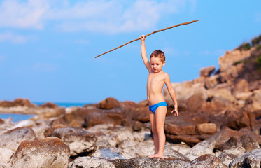 boy with spear pretends like he is on desert island