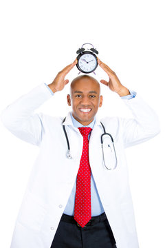Portrait happy smiling male doctor with alarm clock