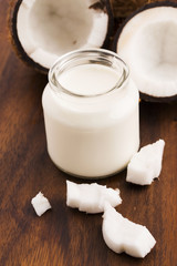 Coconut Milk in a glass on dark wooden background