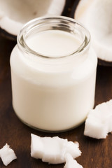 Coconut Milk in a glass on dark wooden background