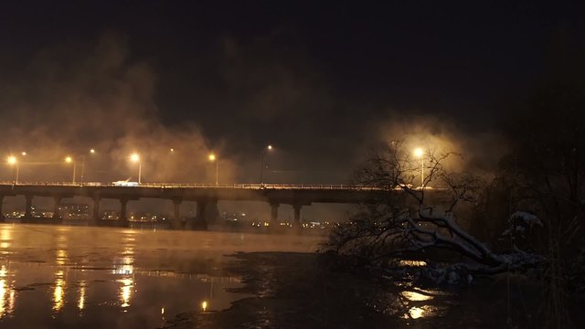 Winter time, night and the river with bridge