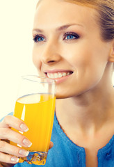 Portrait of young woman drinking orange juice