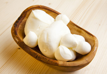 mozzarella cheese in wooden bowl