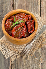 sun dried tomatoes with olive oil on wooden surface