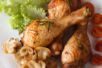 Fried chicken legs with mushrooms close-up. horizontal top view