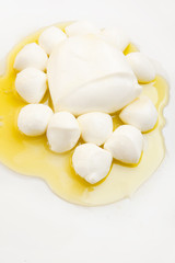 Various types of mozzarella cheese on olive oil with empty space