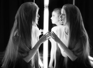 sexy girl and her reflection in mirror table