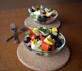 Healthy vegetable salad with eggs in the glass bowl