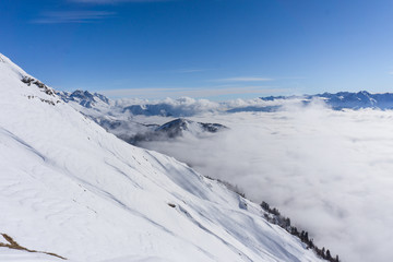 View on mountains and blue sky above clouds