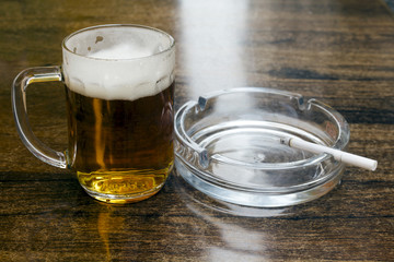 glass of beer and an ashtray