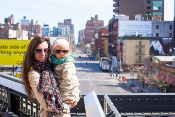 Adorable little girl and mother enjoy sunny day on New York's