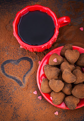 Heart shaped chocolate truffles and cup of coffee