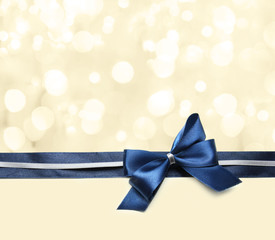 Color satin ribbon bow on bright background