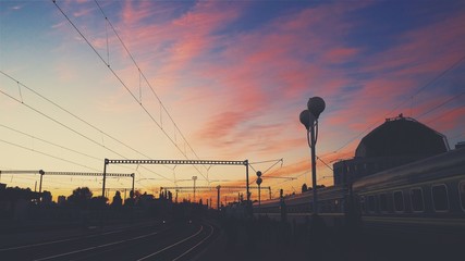 Obraz premium Sunset on the railway. Train on the beautiful sky background