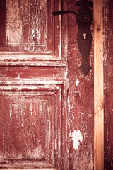 Closeup old wooden door with metal handle