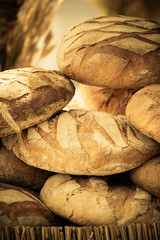 many brown rustic fresh rye bread loaves